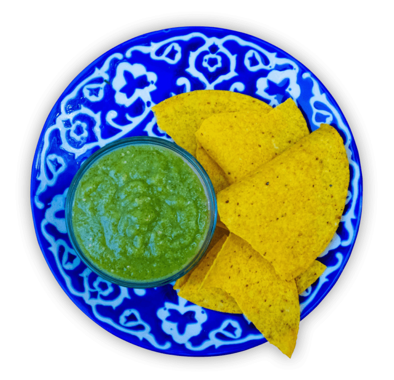 Chip on a blue plate with green sauce