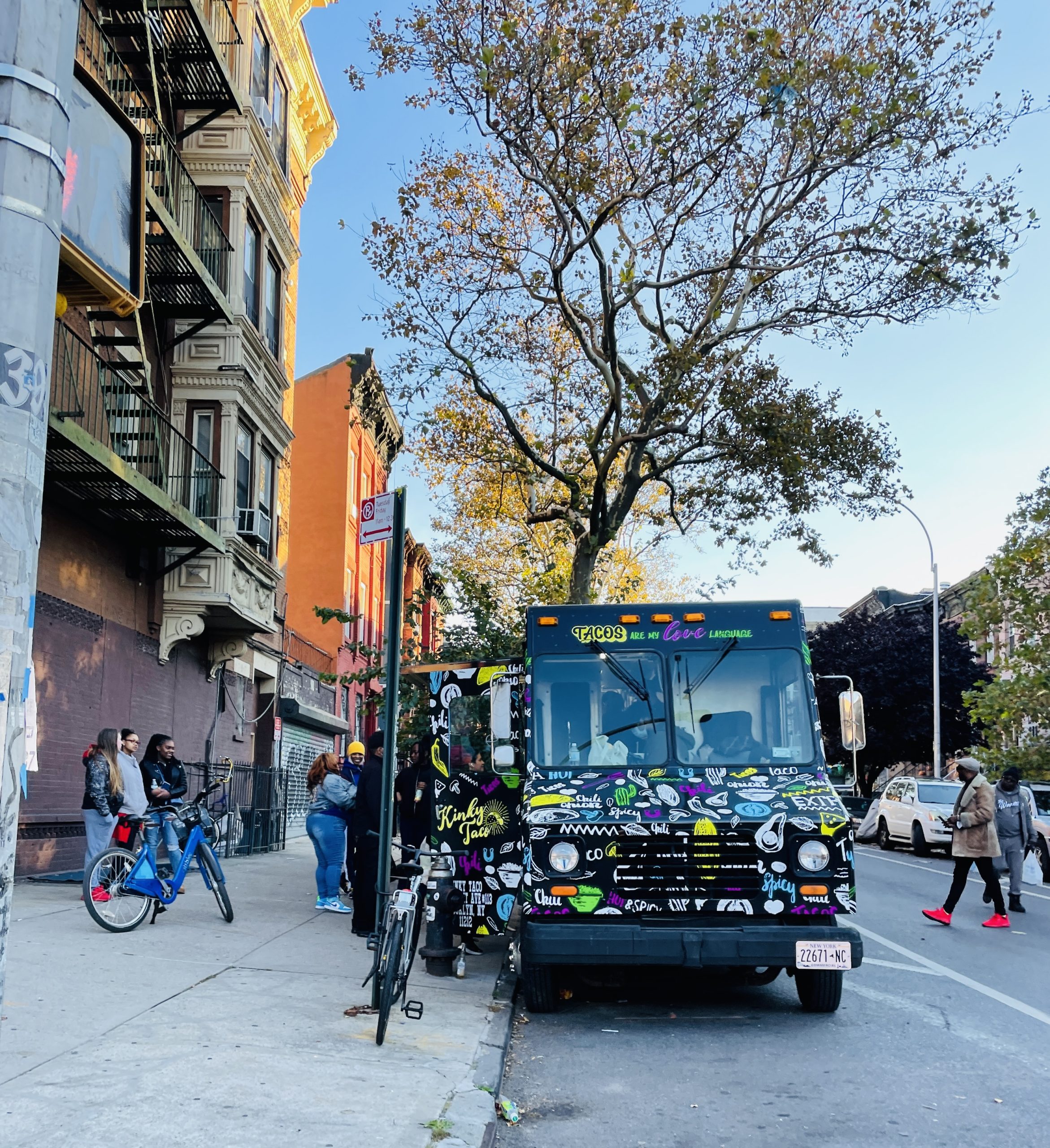 Kinky Taco Truck on the streets of New York City with people ordering at the window